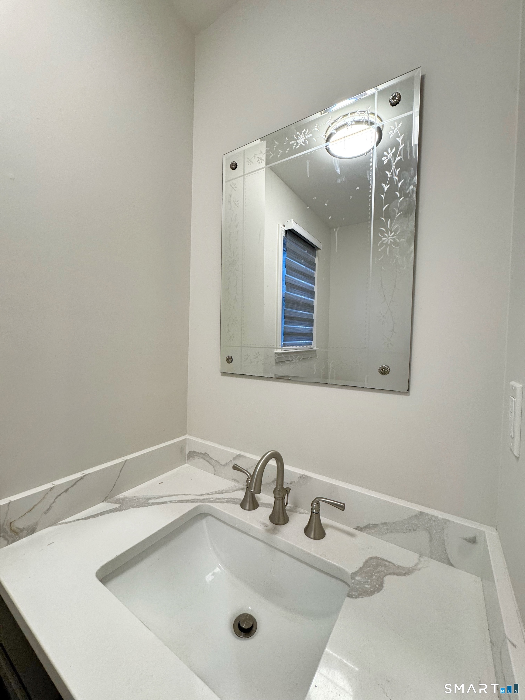 36 Chapel Street, Unit 1 Norwalk, CT 06850 - Photo 10 of 11 a bathroom with a sink and mirror