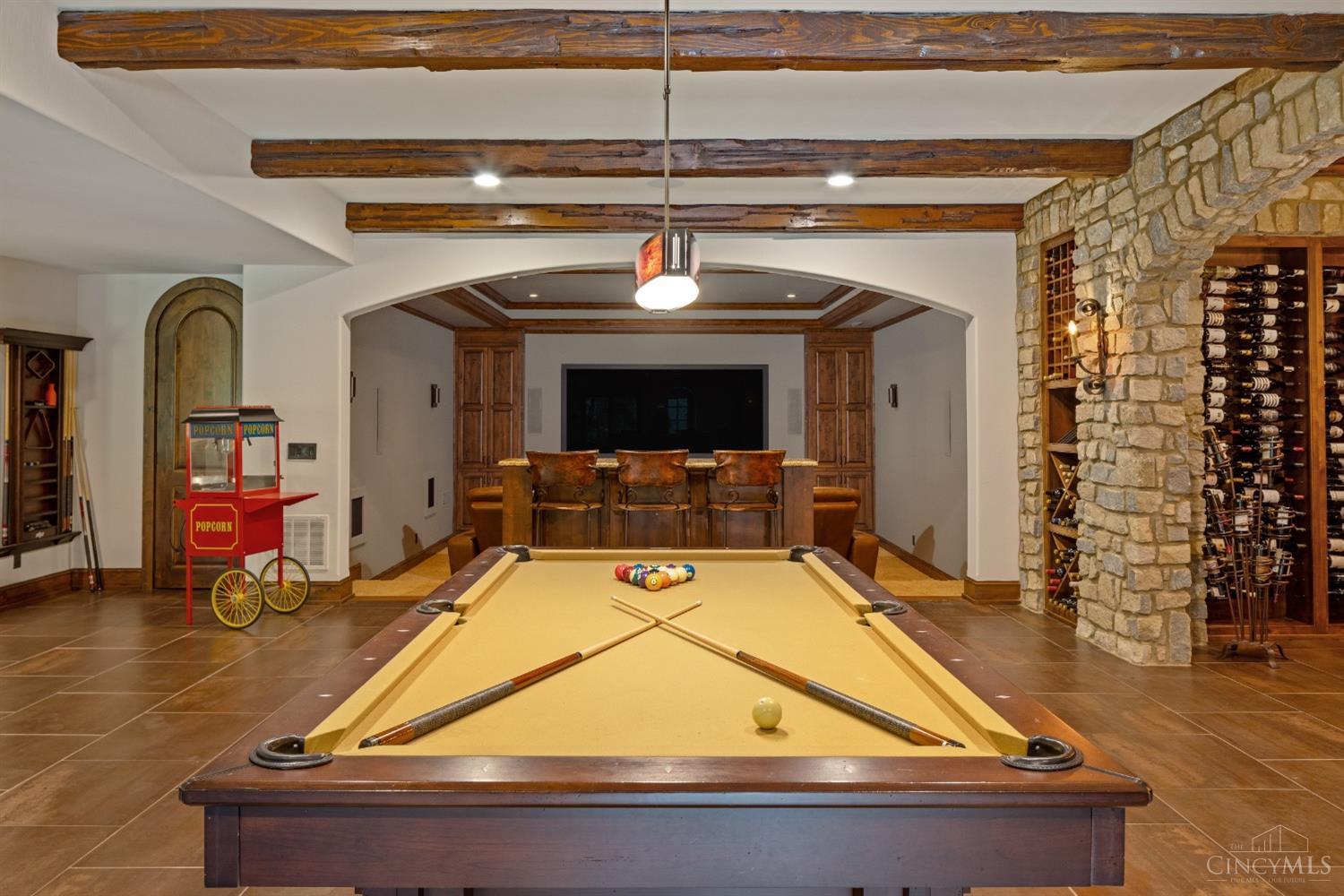 5900 Park Road Cincinnati, OH 45243 - Photo 30 of 50 View of massive theater/media room (21’ X 20’) from pool table area (32’ X 18’) Note: The media room features a trayed ceiling with recessed lighting, a large Stewart brand screen, and comfortable seating for eight.