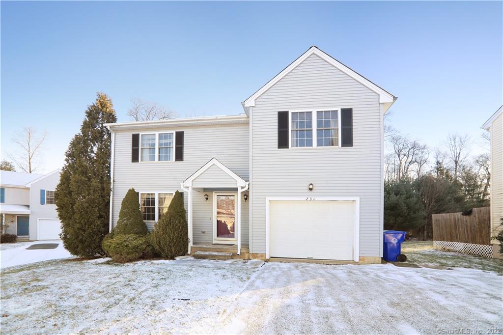 a view of a white house with a yard and large tree