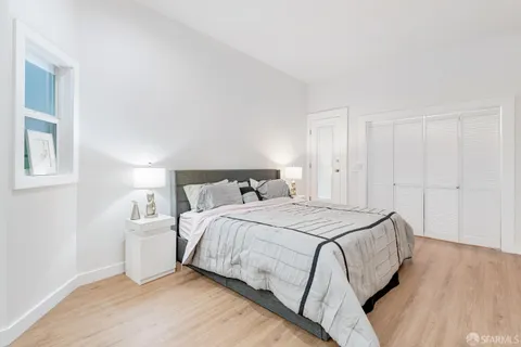 a bedroom with a bed and a night stand