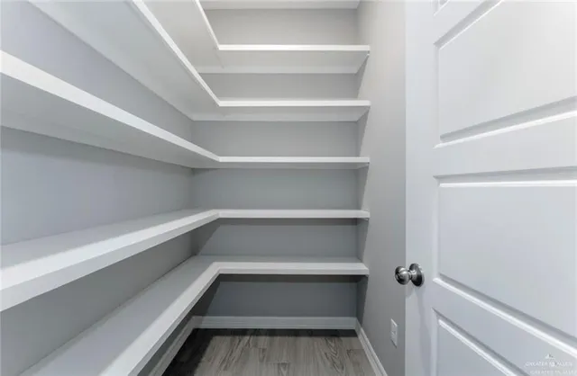 a view of walk in closet with empty racks