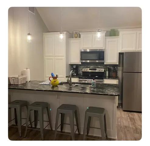 a kitchen with stainless steel appliances granite countertop a refrigerator and a sink