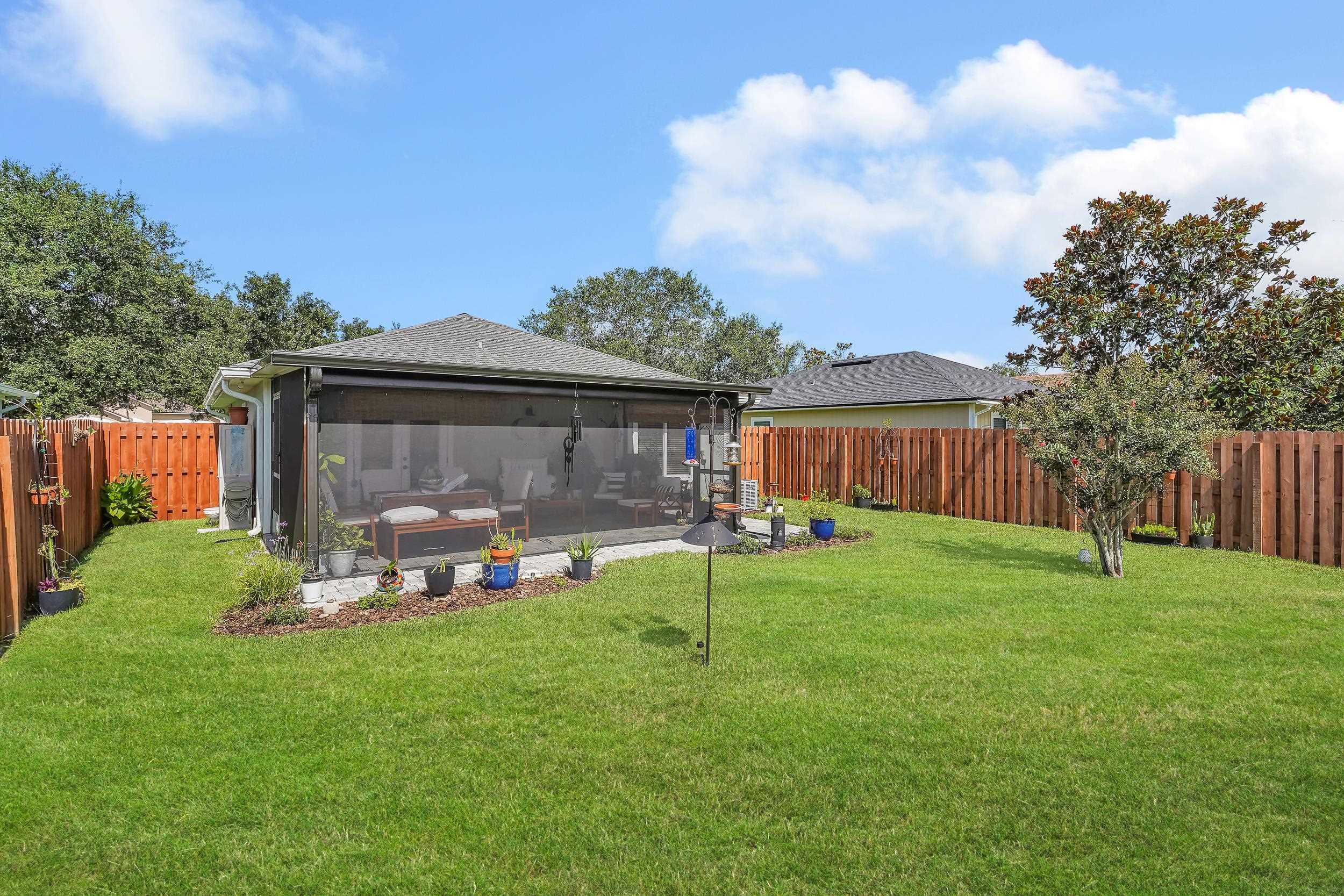 891 Wynfield Circle St. Augustine, FL 32092 - Photo 26 of 37 a view of a house with backyard and a tree