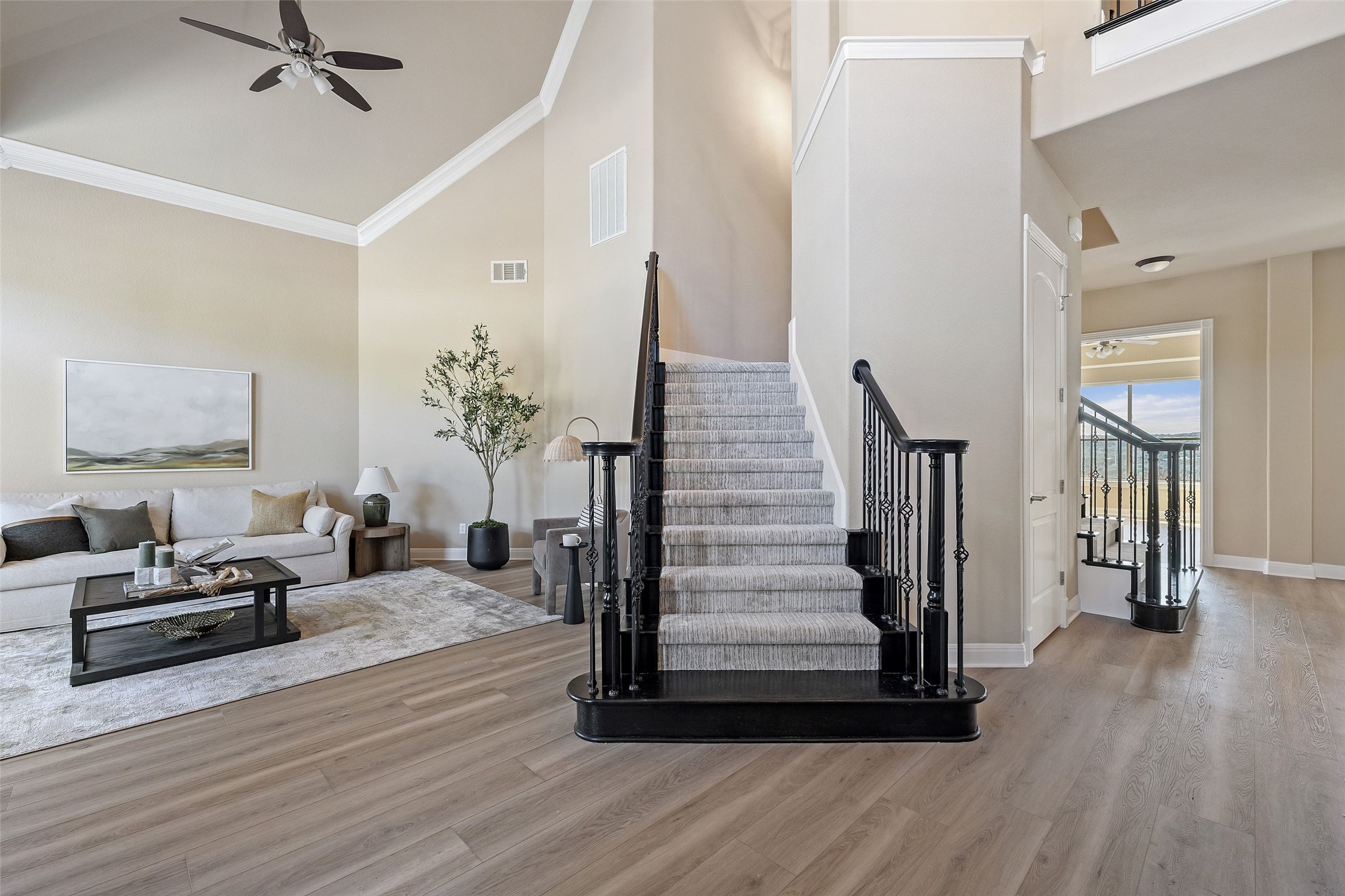 2702 Lakehurst Road Spicewood, TX 78669 - Photo 18 of 40 a view of a livingroom with wooden floor and stairs