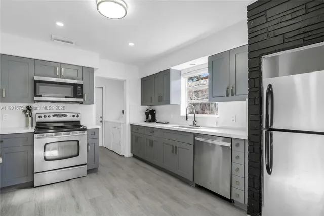 a kitchen with a refrigerator stove and sink