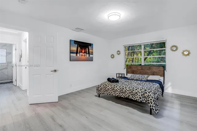 a bedroom with a bed and a window