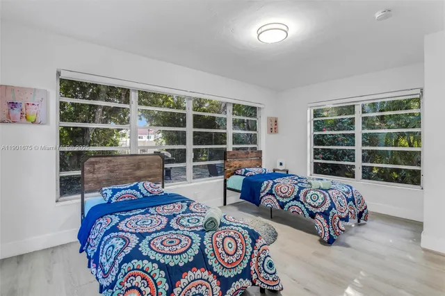 a bedroom with bed and a window