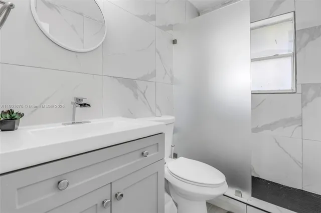 a bathroom with a sink a toilet and vanity