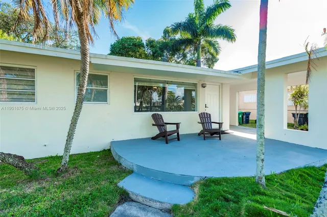 a view of a backyard with a patio and outdoor seating