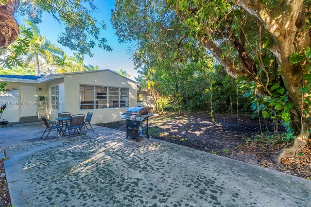a view of a house with a yard and sitting area