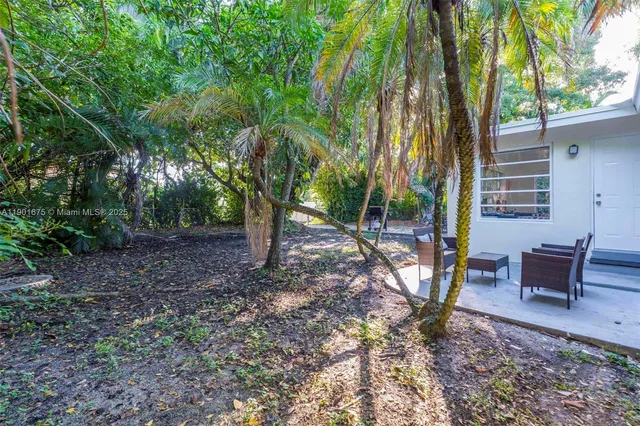 a backyard of a house with outdoor seating