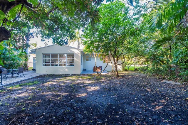 a view of a house with yard and a tree