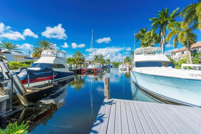 a view of swimming pool with lounge chair and potted plants