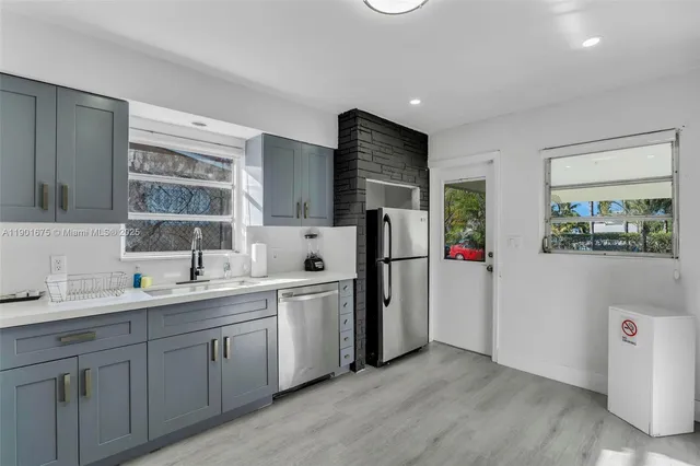 a kitchen with refrigerator and sink