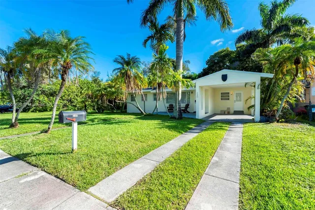 a front view of a house with a yard table and chairs