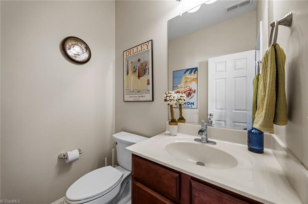 3464 Basalt Court High Point, NC 27265 - Photo 17 of 40 Convenient main-level half bath with neutral finishes and clean, timeless cabinetry.