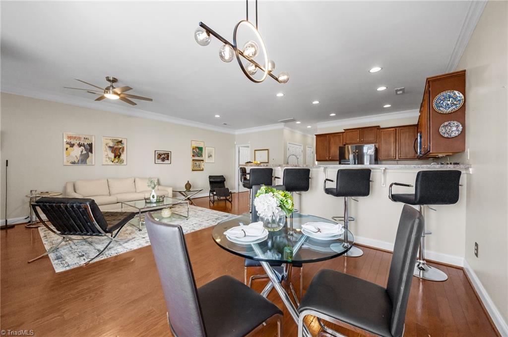 3464 Basalt Court High Point, NC 27265 - Photo 7 of 40 Kitchen with bar seating that flows seamlessly into the living and dining areas — ideal for entertaining.