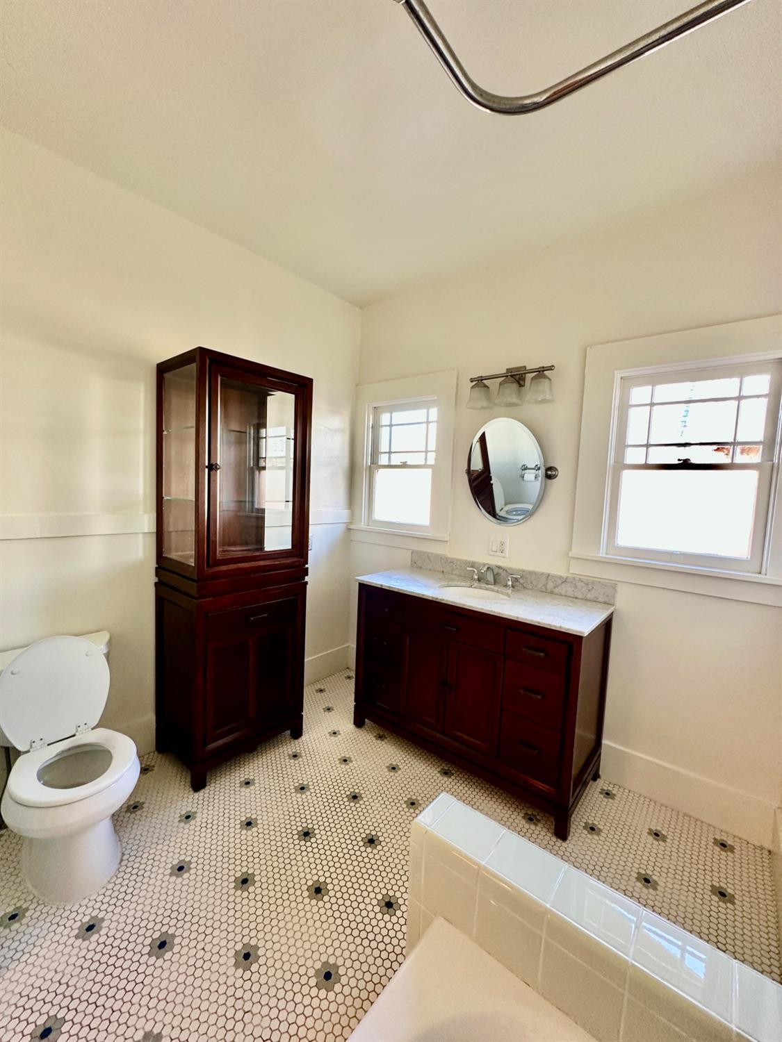 1059 Q Street Newman, CA 95360 - Photo 13 of 29 a bathroom with a sink toilet a mirror and bathtub
