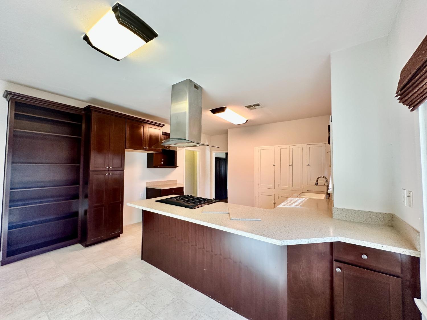 1059 Q Street Newman, CA 95360 - Photo 20 of 29 a kitchen with a refrigerator and a sink