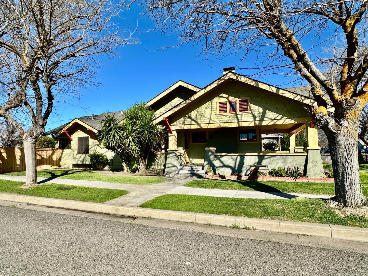1059 Q Street Newman, CA 95360 - Photo 2 of 29 a front view of a house with a yard