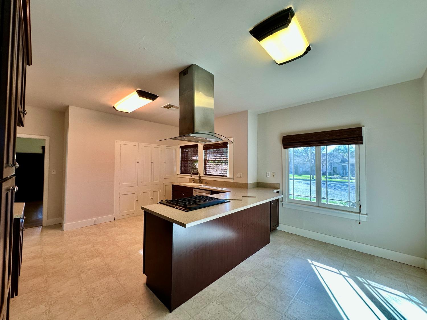 1059 Q Street Newman, CA 95360 - Photo 21 of 29 a kitchen with cabinets and window