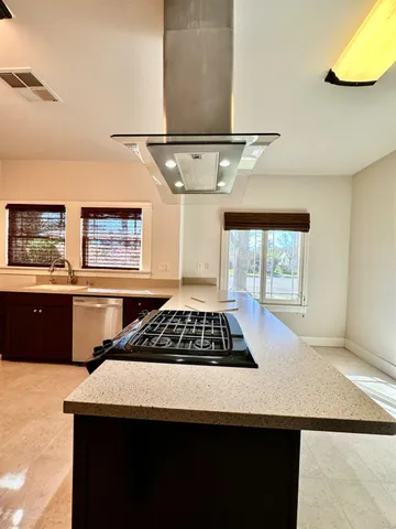 a kitchen with stainless steel appliances granite countertop a sink stove and cabinets
