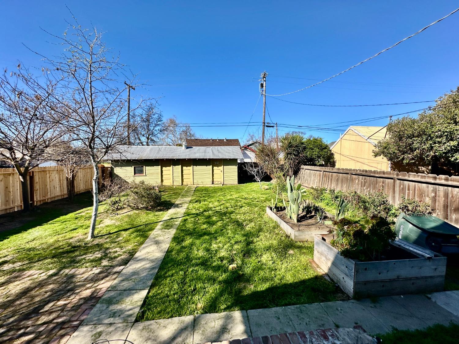 1059 Q Street Newman, CA 95360 - Photo 25 of 29 a front view of a house with garden