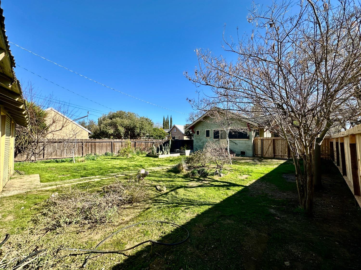 1059 Q Street Newman, CA 95360 - Photo 27 of 29 a front view of a house with garden
