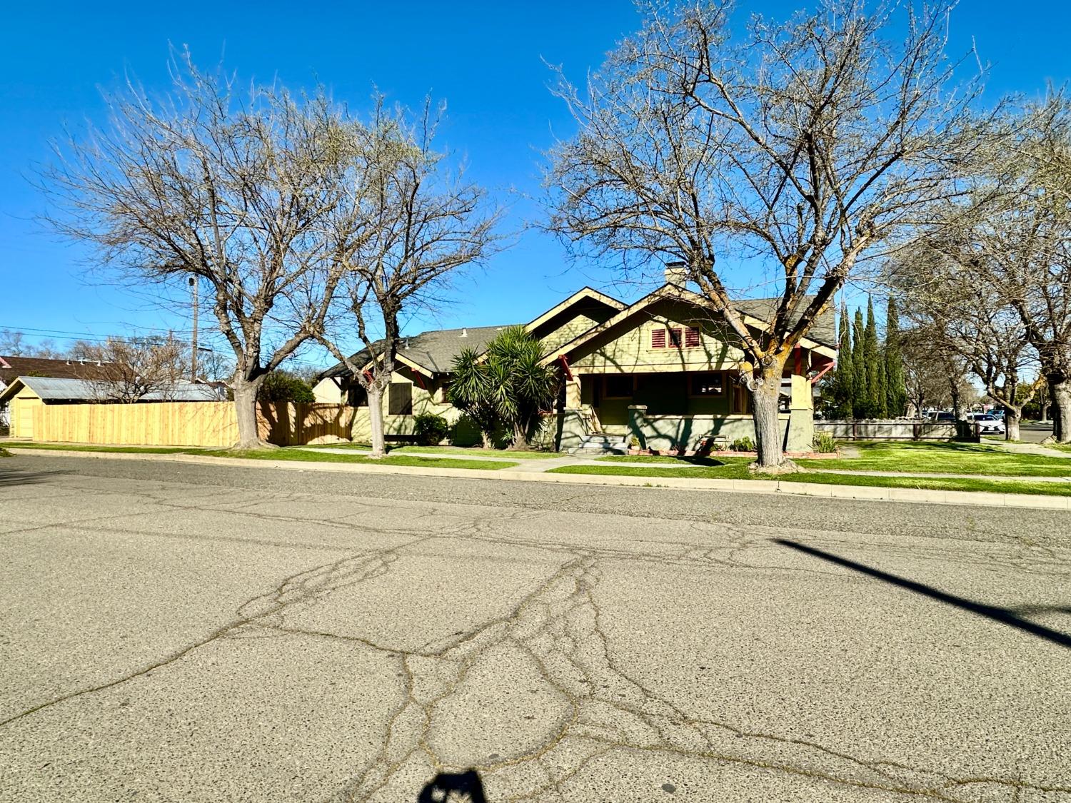 1059 Q Street Newman, CA 95360 - Photo 29 of 29 a view of a house with a yard and a large tree