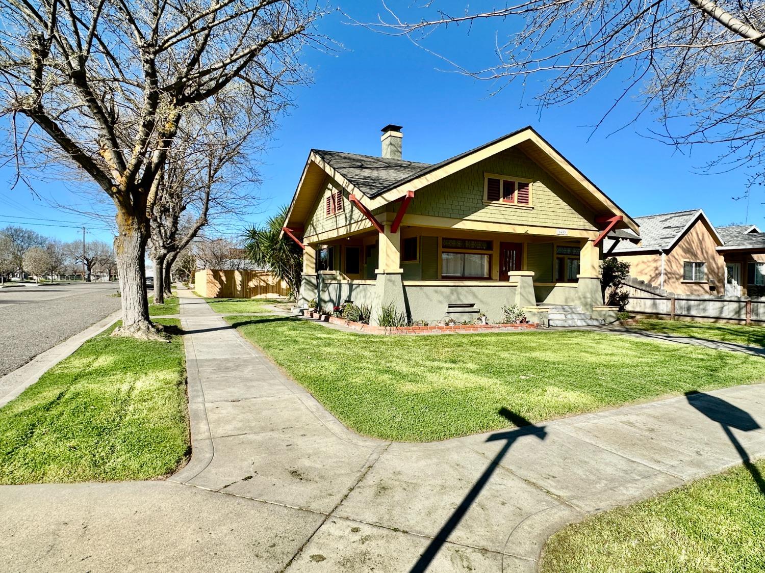 1059 Q Street Newman, CA 95360 - Photo 4 of 29 a front view of a house with garden