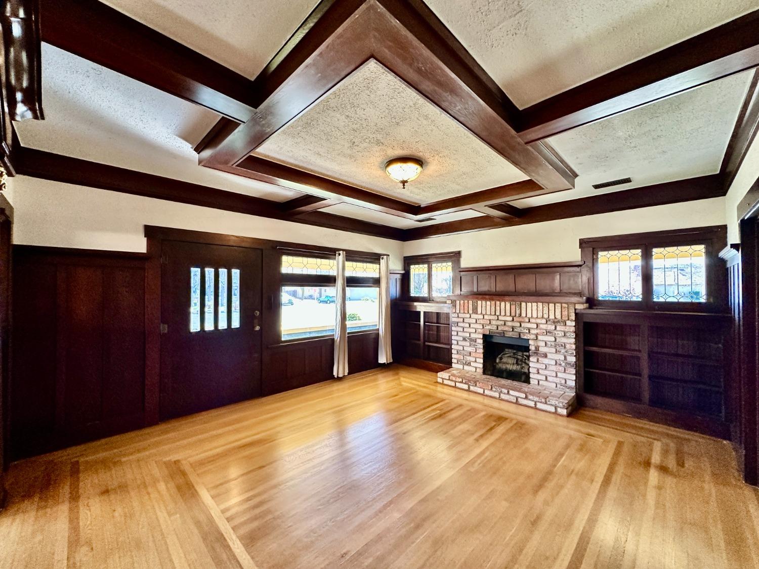 1059 Q Street Newman, CA 95360 - Photo 6 of 29 a view of an empty room with a fireplace and a window