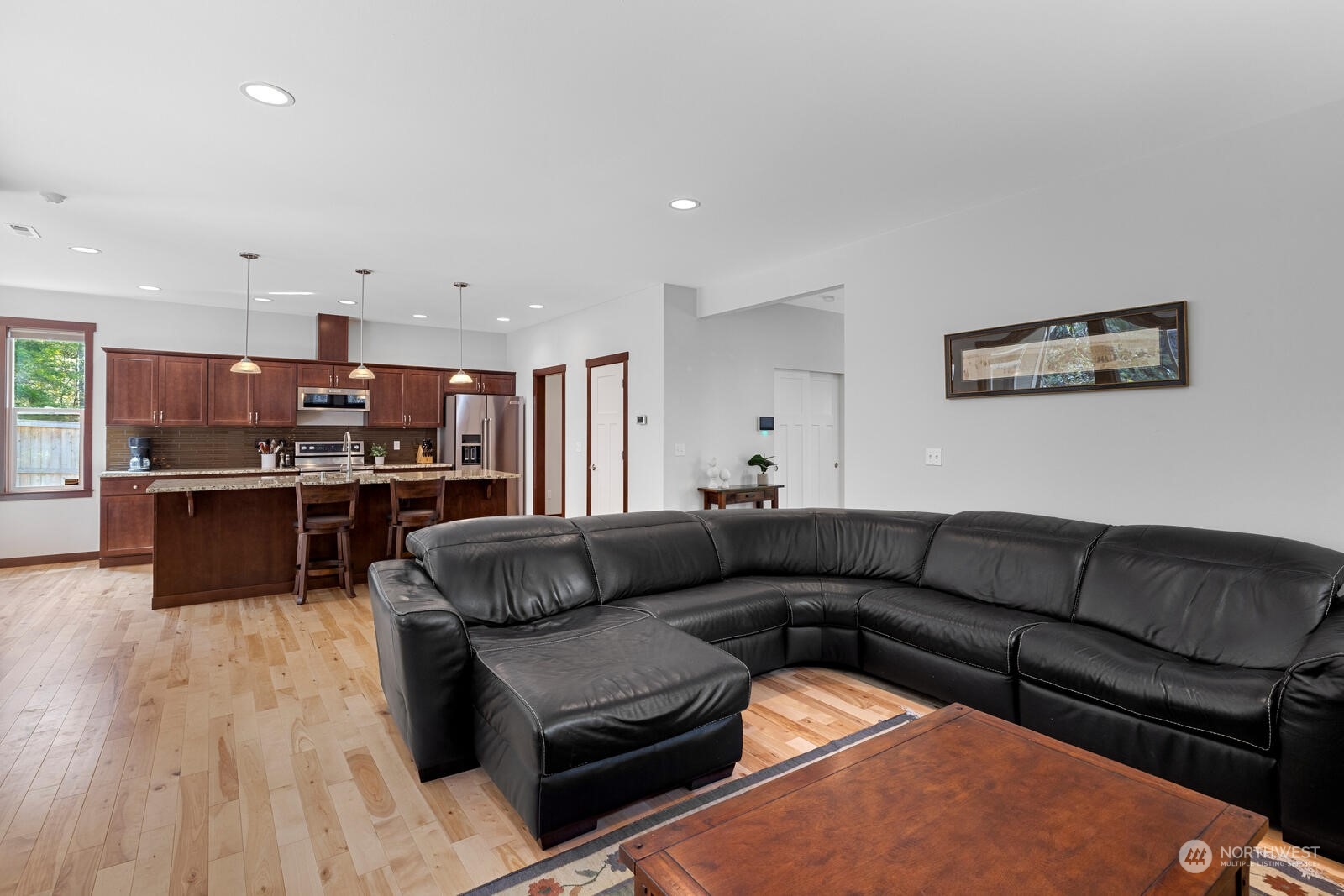 18610 Russian Road Arlington, WA 98223 - Photo 11 of 40 a living room with furniture kitchen view and a wooden floor