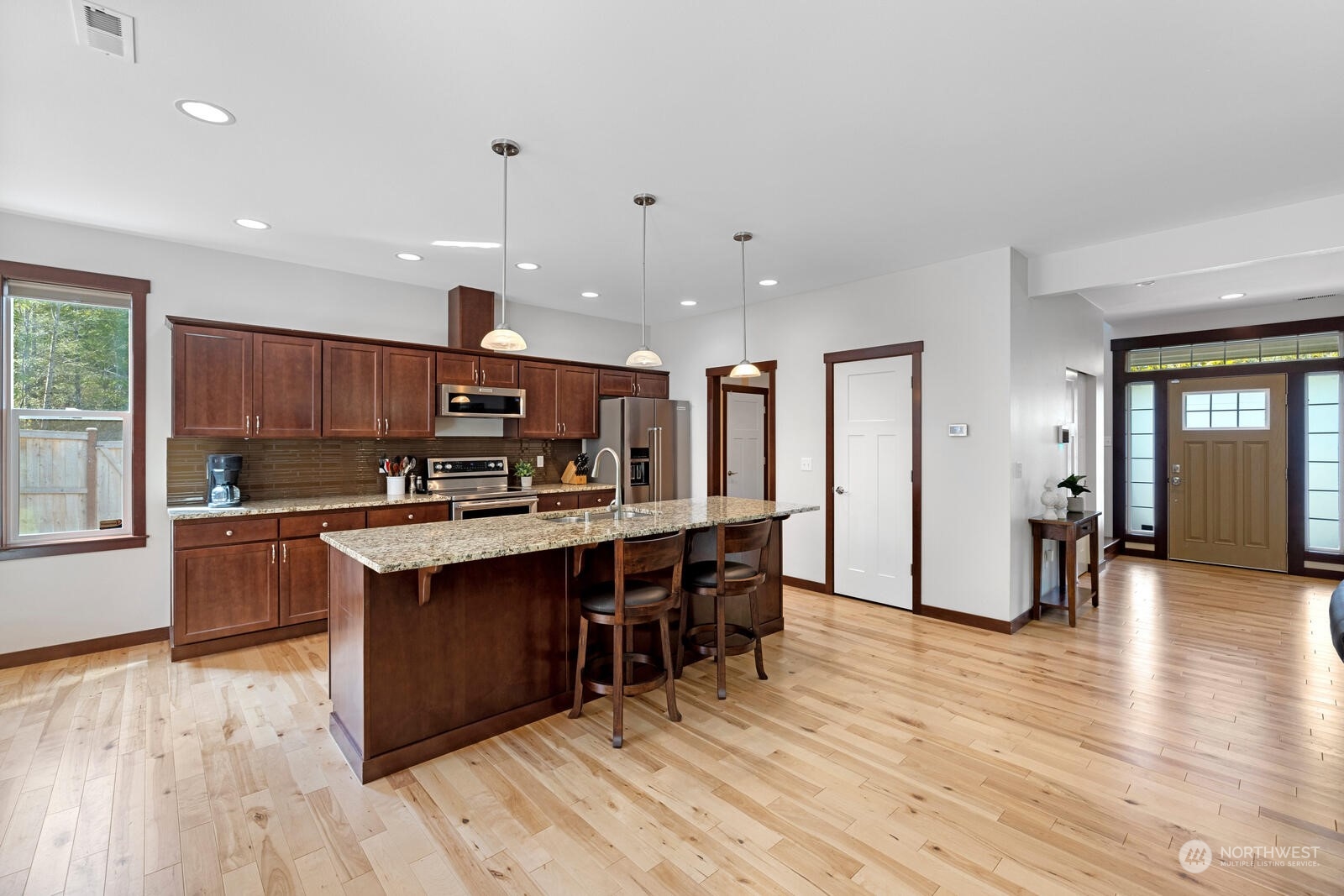 18610 Russian Road Arlington, WA 98223 - Photo 12 of 40 a kitchen with stainless steel appliances kitchen island granite countertop a sink and cabinets