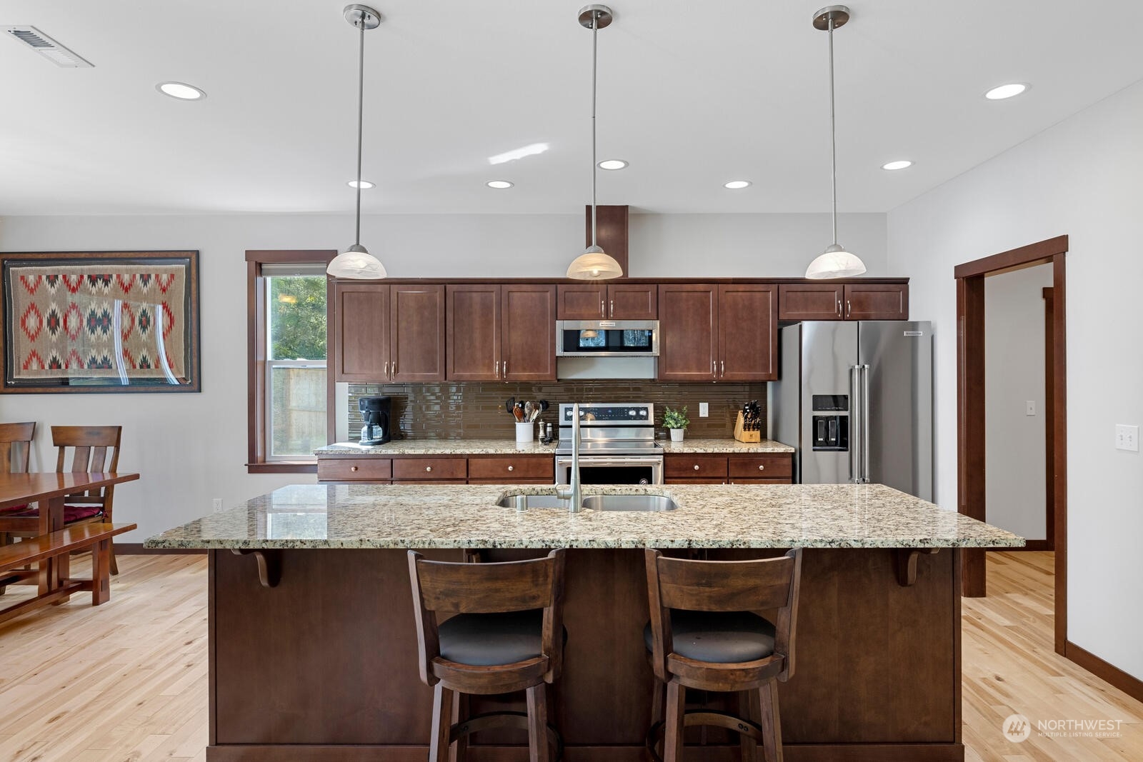 18610 Russian Road Arlington, WA 98223 - Photo 14 of 40 a kitchen with granite countertop a table chairs stainless steel appliances and cabinets