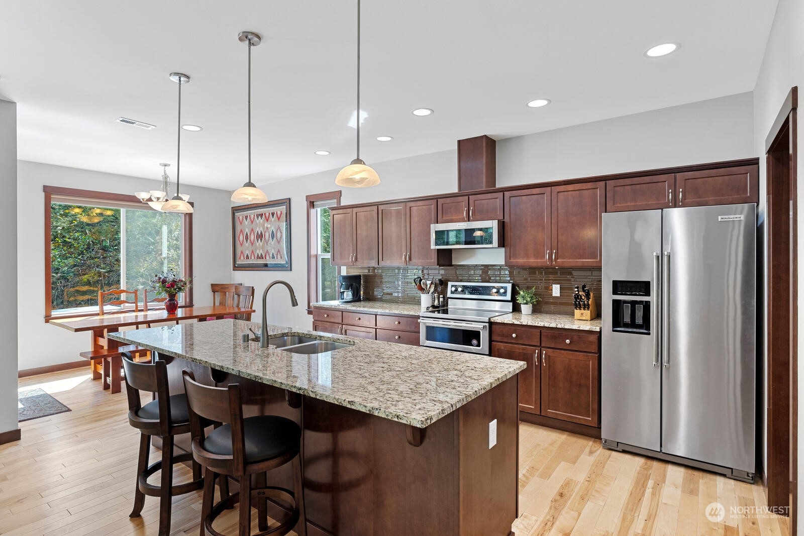 18610 Russian Road Arlington, WA 98223 - Photo 15 of 40 a kitchen with stainless steel appliances granite countertop a kitchen island a stove a table and chairs