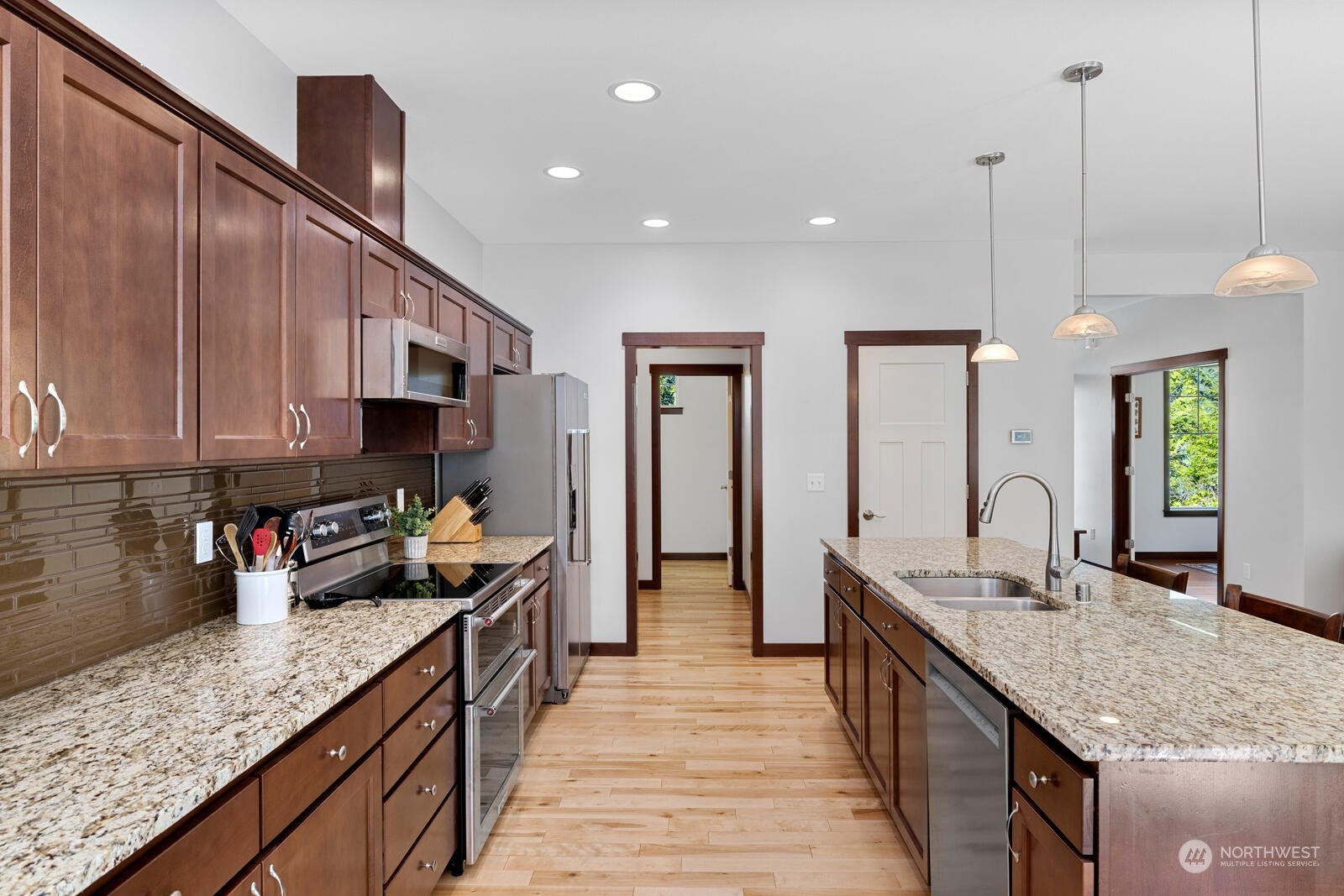 18610 Russian Road Arlington, WA 98223 - Photo 16 of 40 a kitchen with kitchen island granite countertop a sink a counter top space appliances and cabinets