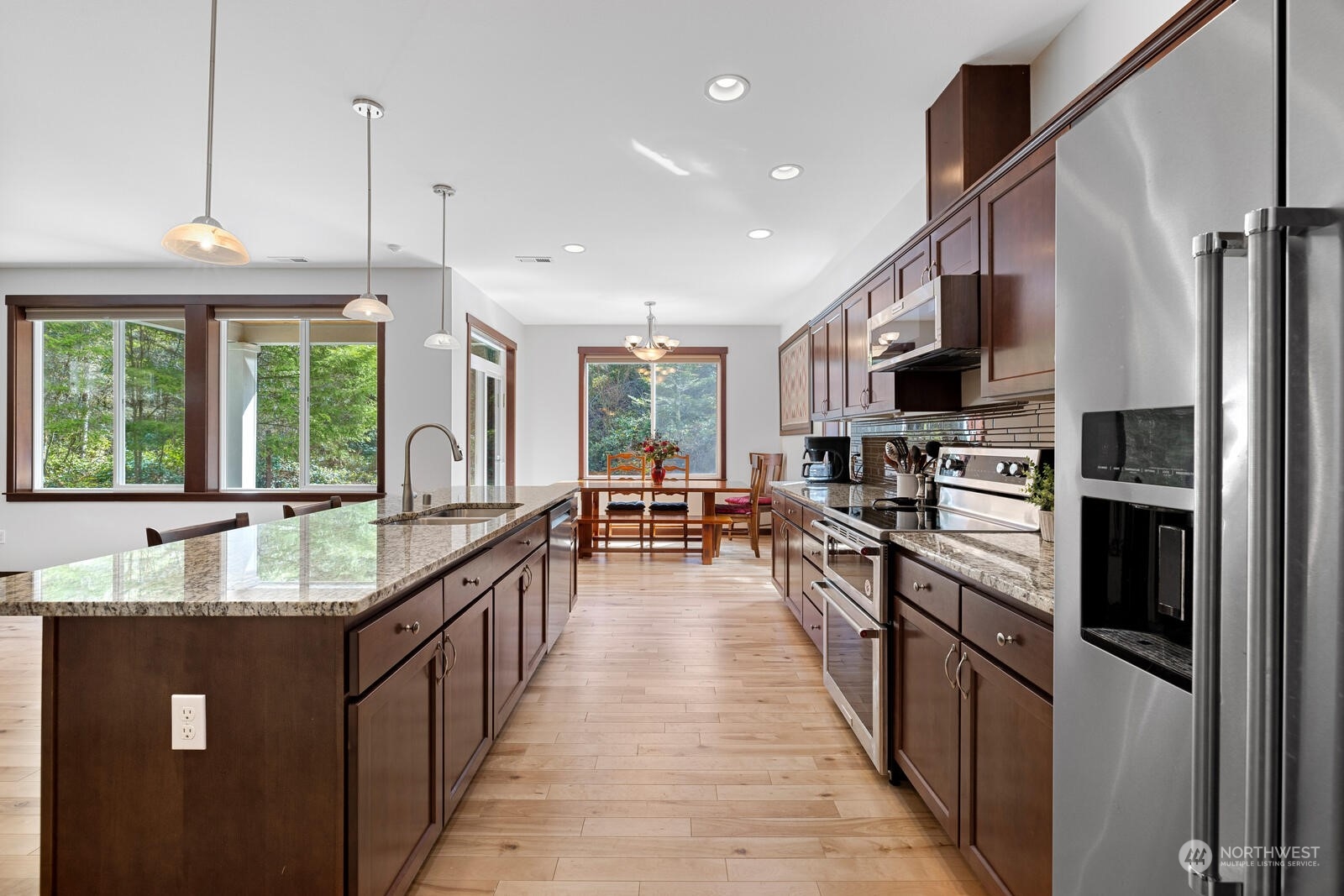 18610 Russian Road Arlington, WA 98223 - Photo 17 of 40 a large kitchen with stainless steel appliances granite countertop a refrigerator a stove and a sink