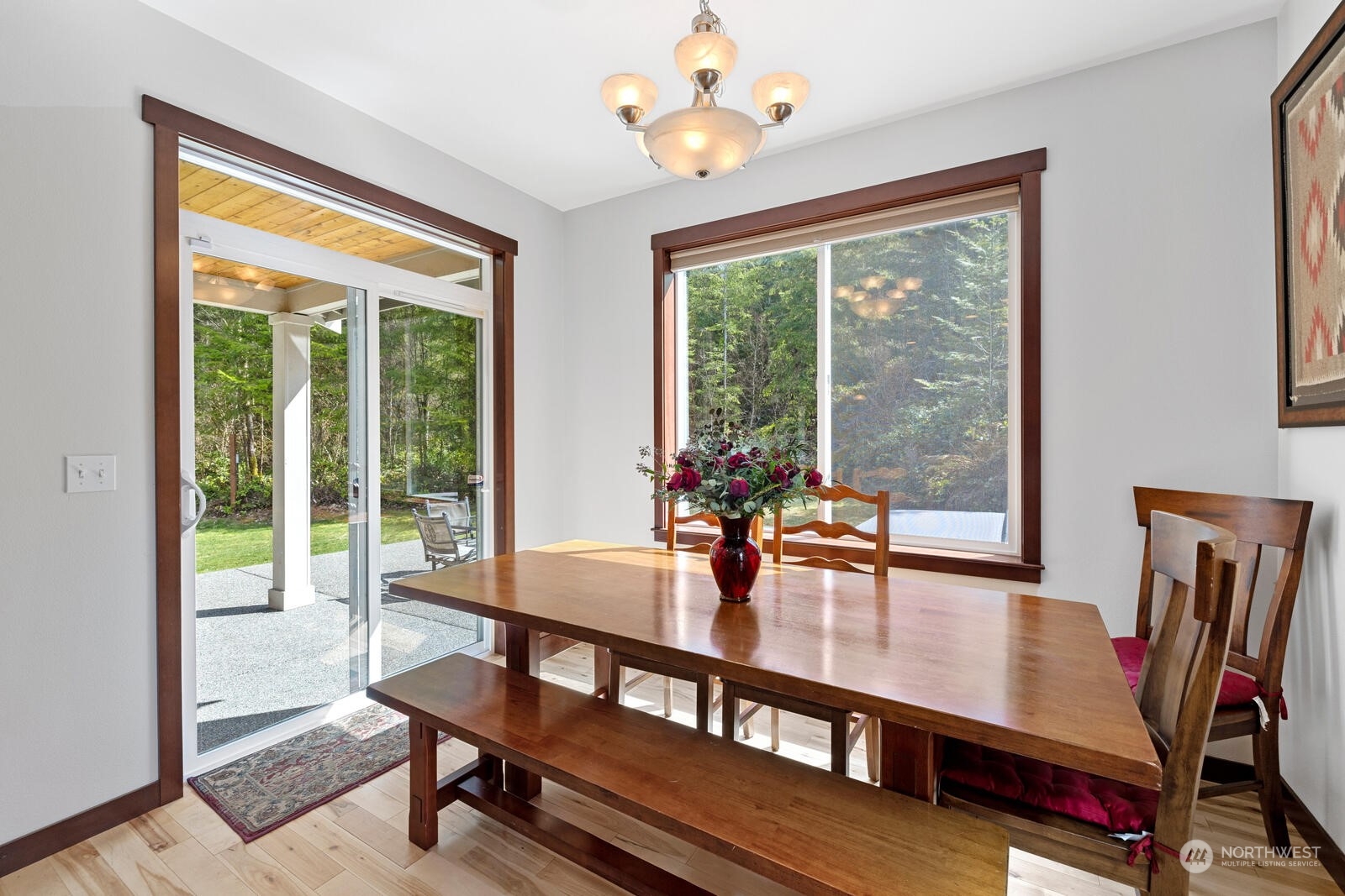 18610 Russian Road Arlington, WA 98223 - Photo 18 of 40 a dining room with furniture a chandelier and wooden floor