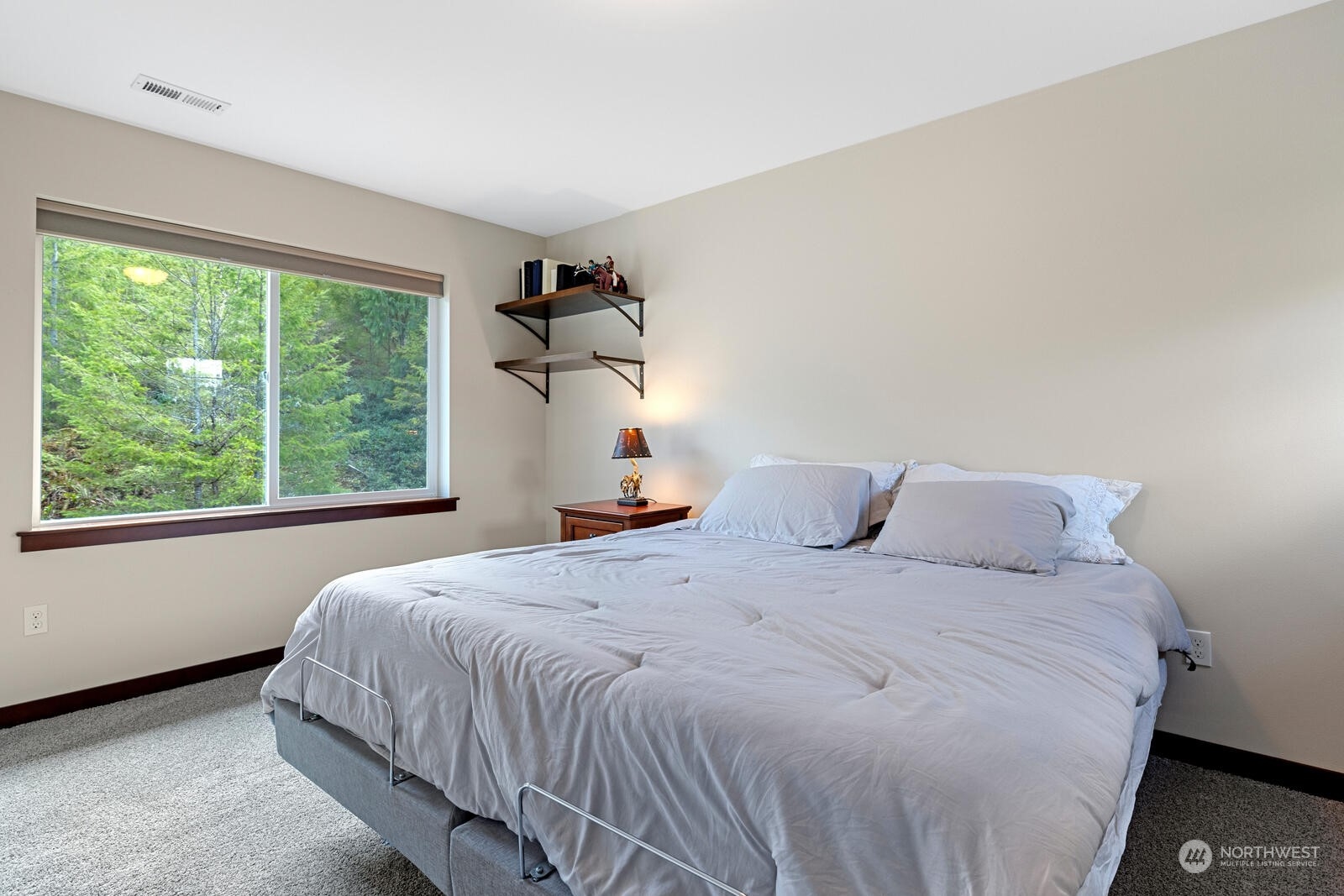 18610 Russian Road Arlington, WA 98223 - Photo 31 of 40 a bedroom with a bed and a large window