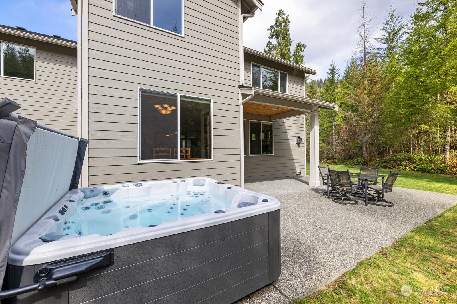18610 Russian Road Arlington, WA 98223 - Photo 35 of 40 a view of a chairs and table in the back yard of the house