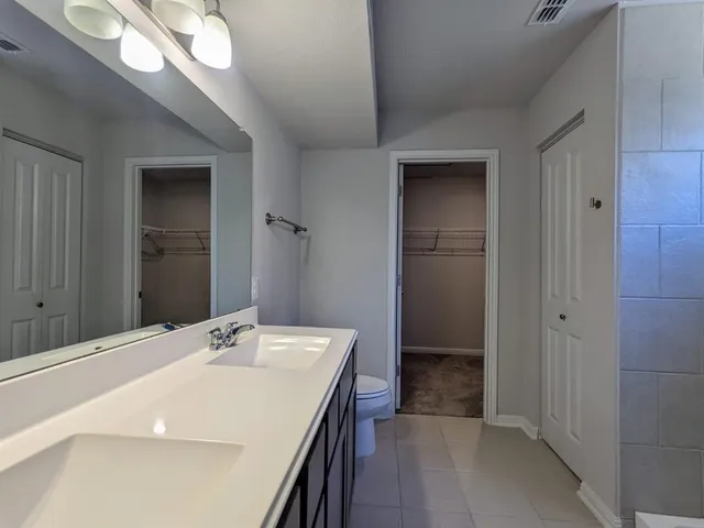 a bathroom with a sink a mirror and a shower