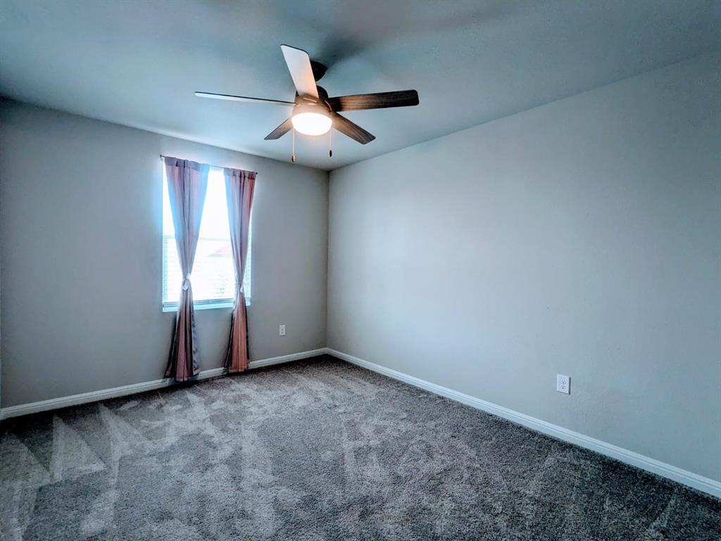196 Martha Lane Kyle, TX 78640 - Photo 19 of 30 an empty room with windows and fan