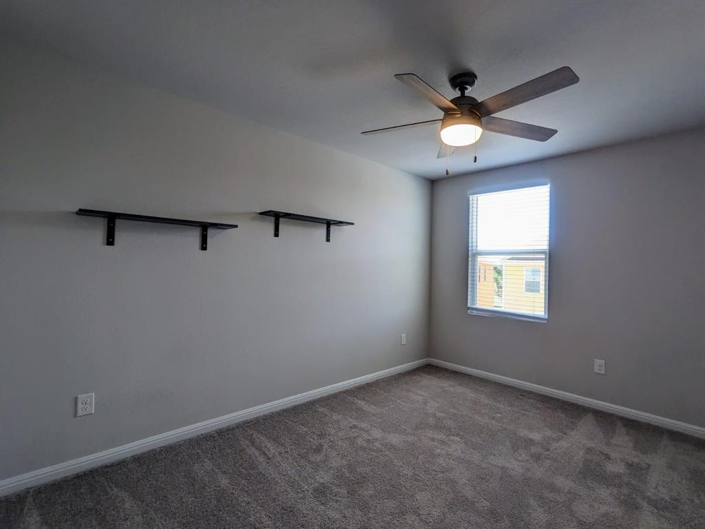196 Martha Lane Kyle, TX 78640 - Photo 20 of 30 an empty room with a window and a fan