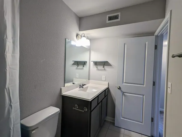a bathroom with a sink toilet and mirror