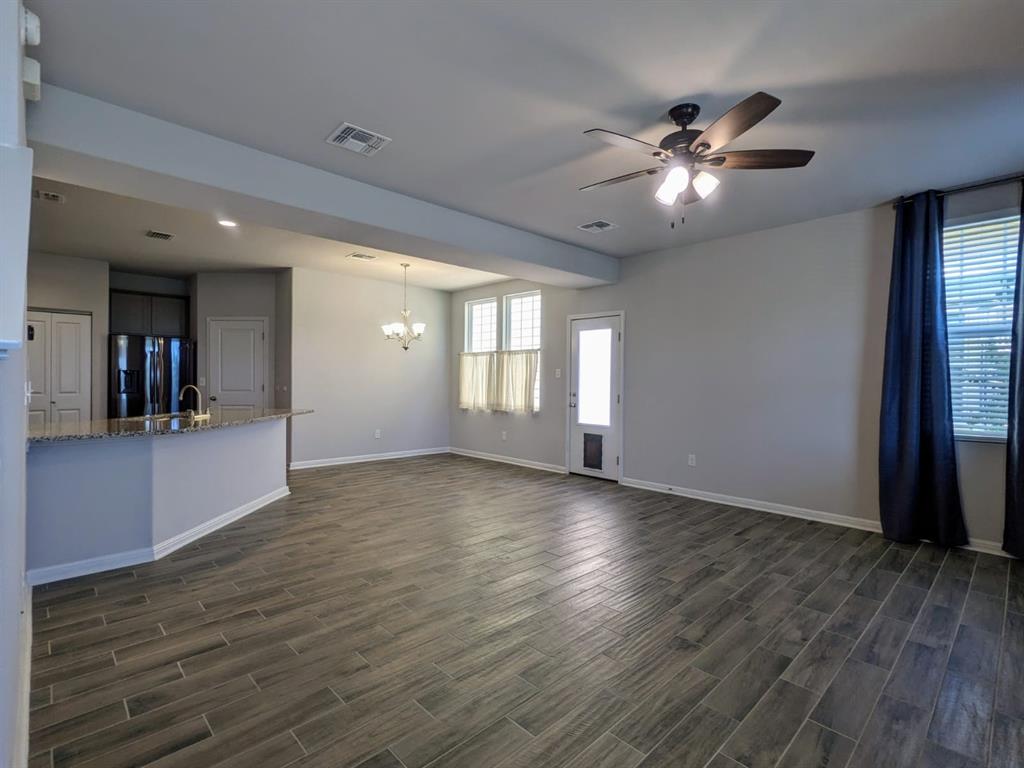 196 Martha Lane Kyle, TX 78640 - Photo 3 of 30 a view of an empty room with window and wooden floor