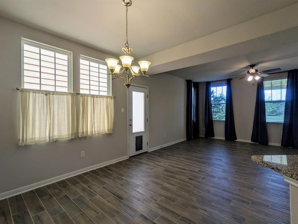 196 Martha Lane Kyle, TX 78640 - Photo 5 of 30 an empty room with wooden floor and windows