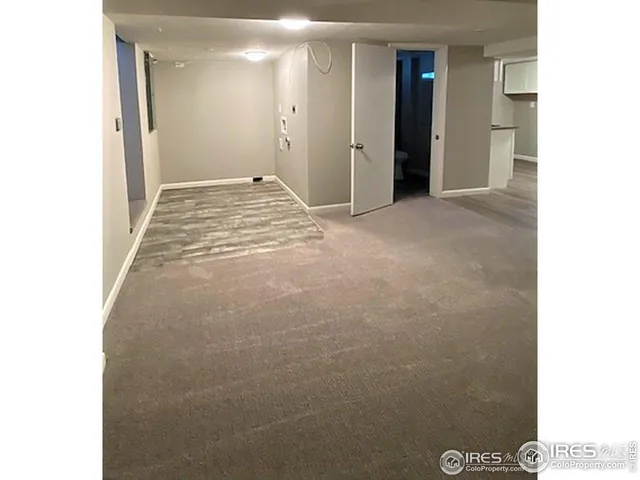 a view of a closet with wooden floor