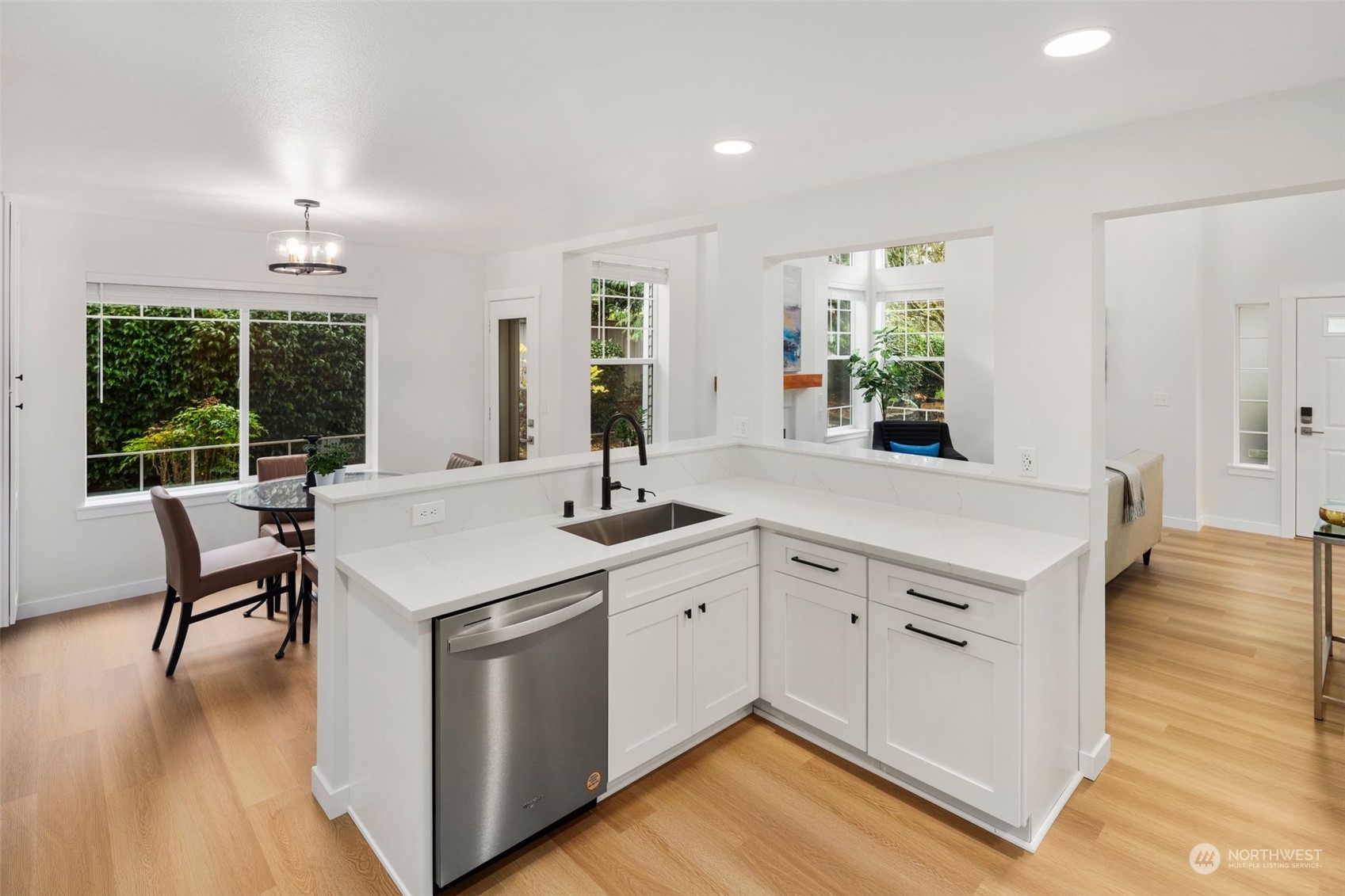19126 110th Place Southeast Renton, WA 98055 - Photo 13 of 40 a kitchen with a stove a sink a dining table and chairs