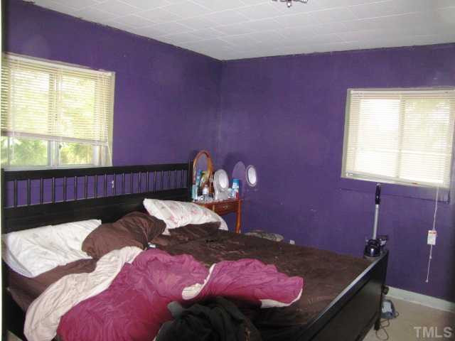 6009 Cheek Road Durham, NC 27704 - Photo 4 of 12 a bed room with a bed
