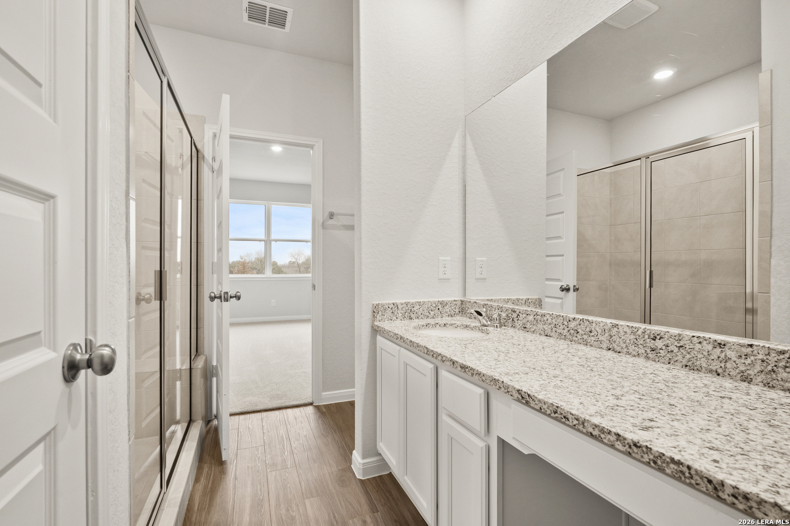 13631 Helton Pass St. Hedwig, TX 78152 - Photo 13 of 33 a bathroom with a granite countertop sink mirror and double